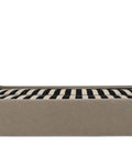 Beige upholstered bed frame with striped mattress on a white background