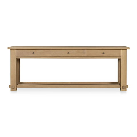 Wooden console table with three drawers on a white background