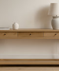 Wooden console table with decorative items against a plain wall