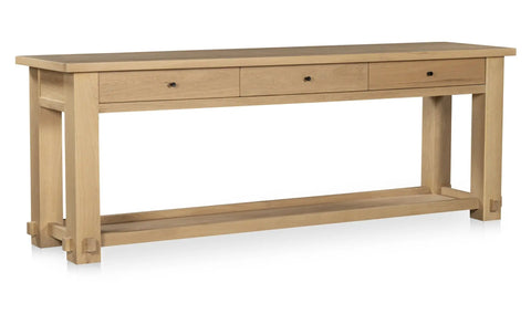 Wooden console table with three drawers on a white background
