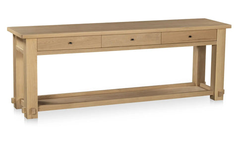Wooden console table with three drawers on a white background