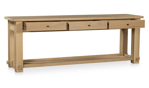 Wooden console table with three drawers on a white background