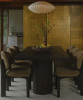 Dining area with a dark wooden table and chairs in a modern interior setting.