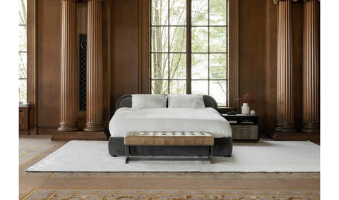 Modern bedroom with a bed, nightstands, and large windows.