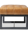 Brown leather ottoman with black metal frame on a white background